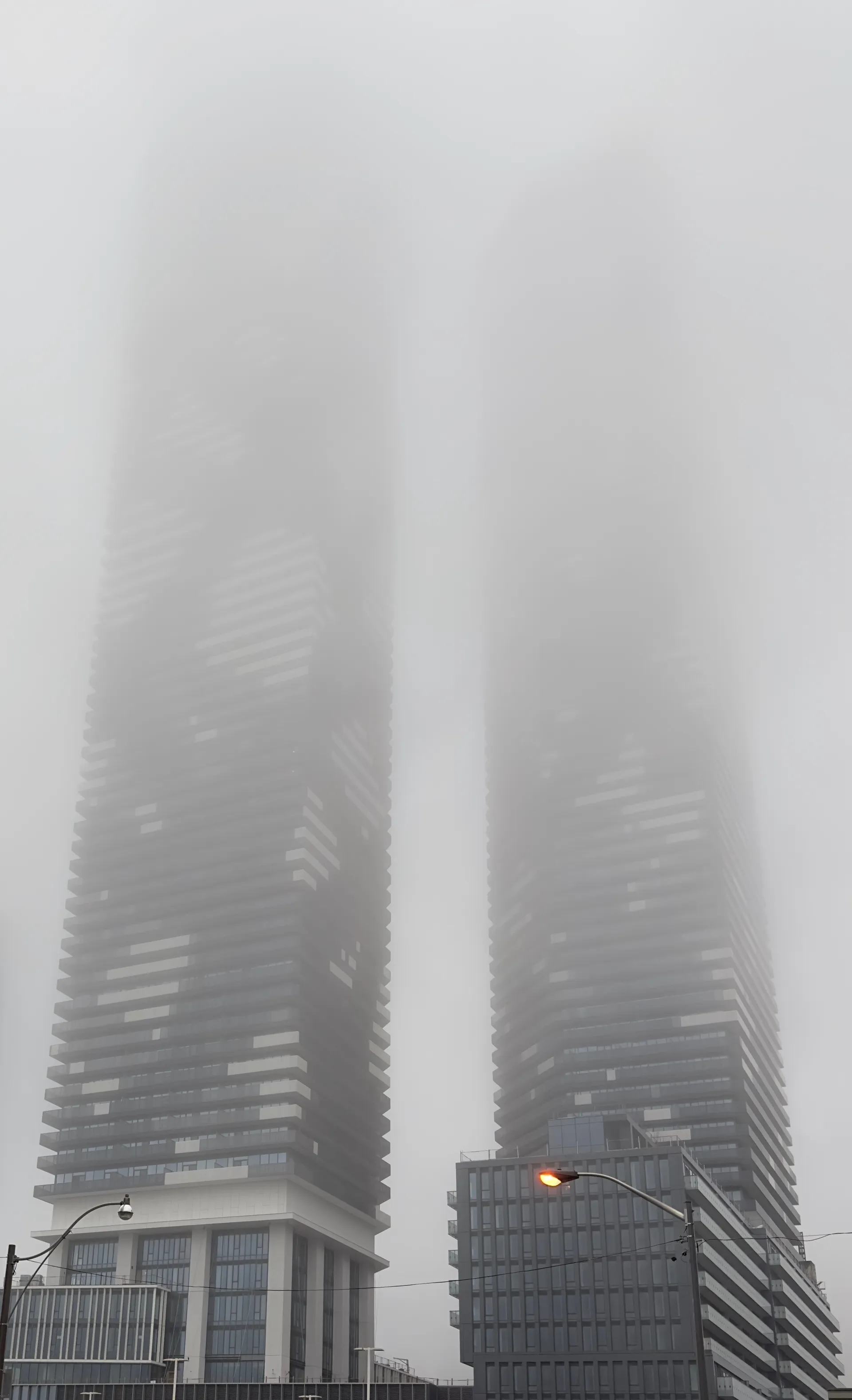 Two residential towers in Toronto disappearing into fog