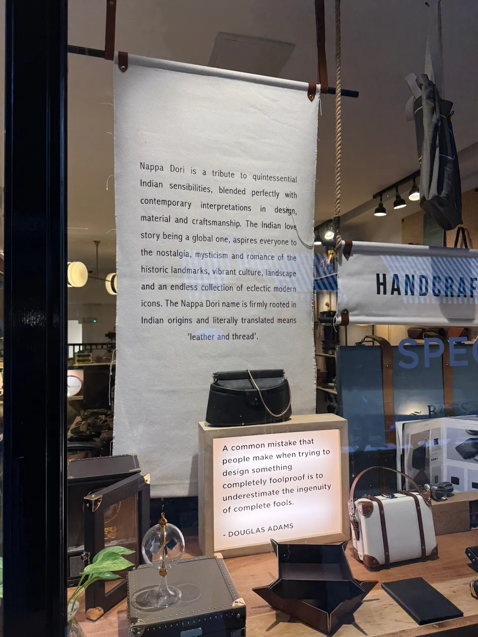 A placard quoting Douglas Adams in a storefront