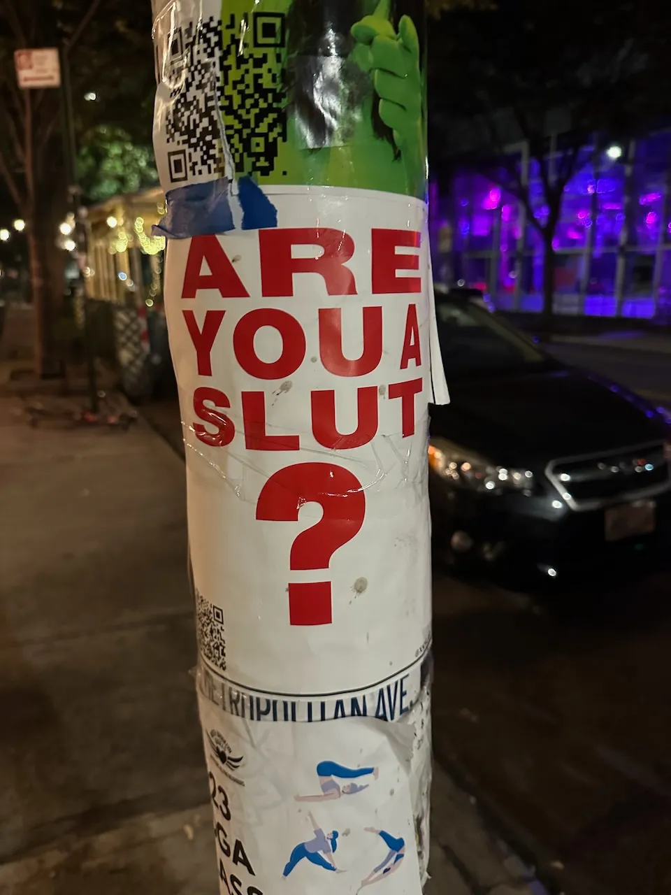 Poster reading "Are You A Slut?" on a pole in New York City