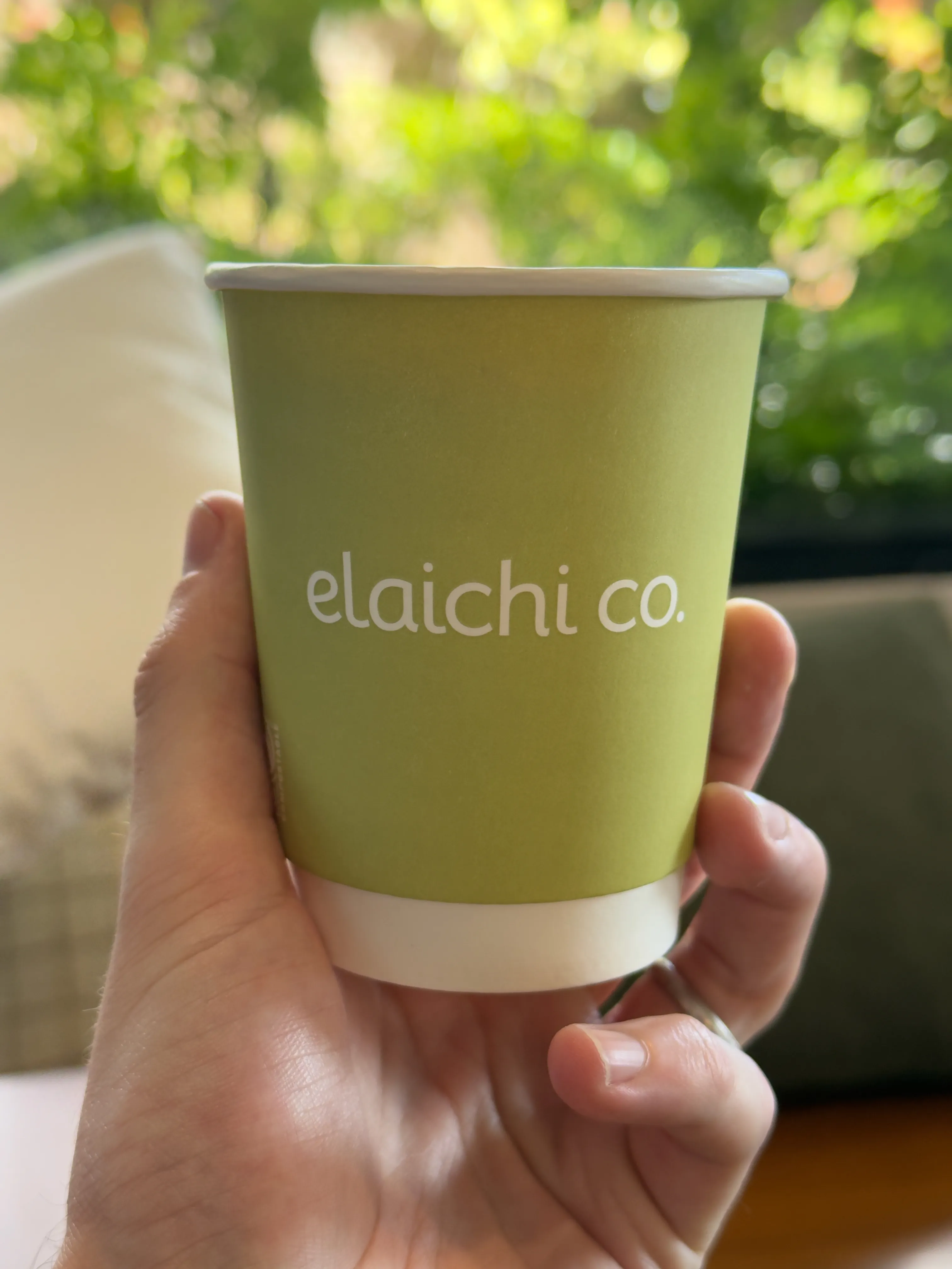 Back side of a coffee cup from elaichi co, featuring the company name