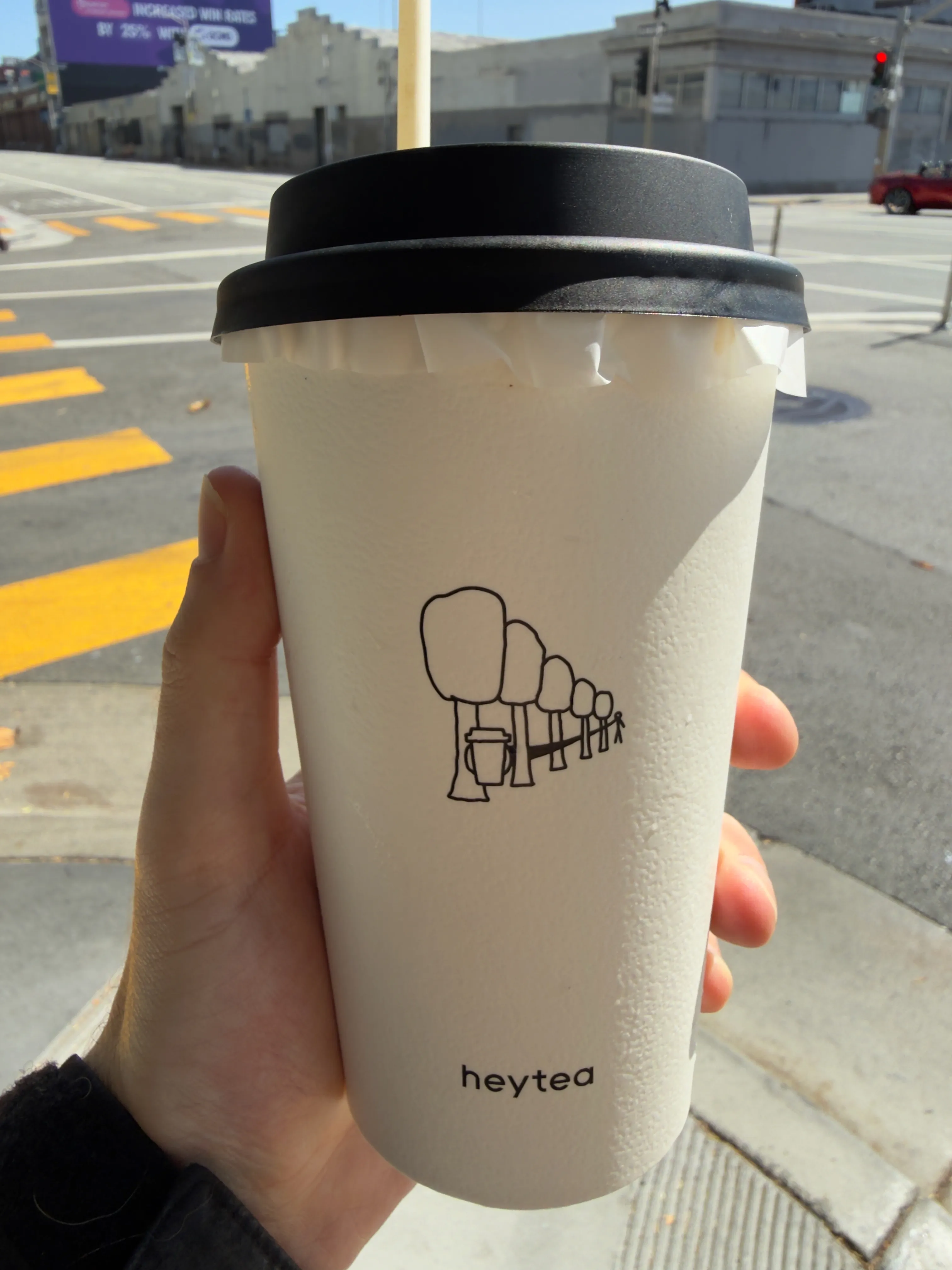 Back side of a tea cup from Heytea, showing a stylized cartoon of a forest Back side of a tea cup from Heytea, showing a stylized cartoon of a forest