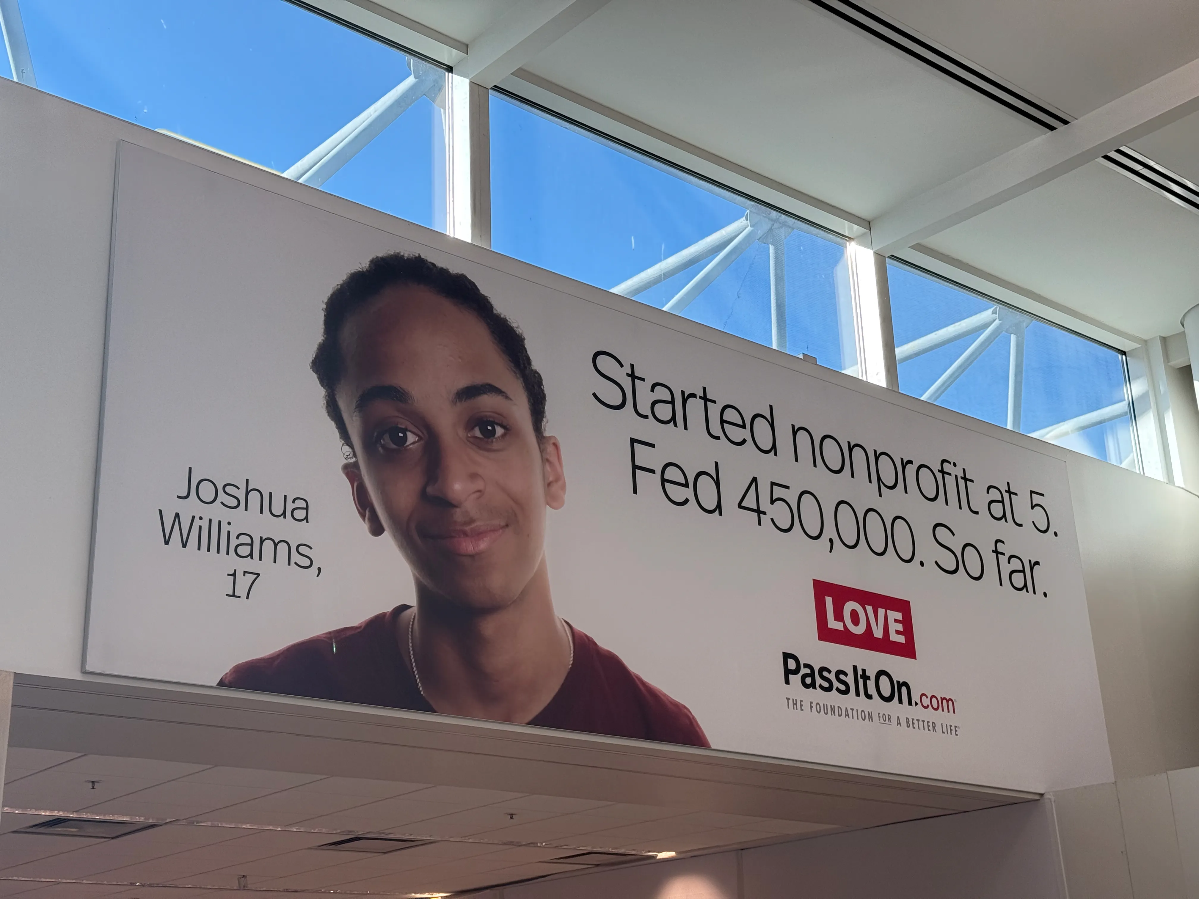 A billboard at OAK Airport explaining that Joshua Williams started his charity at age 5