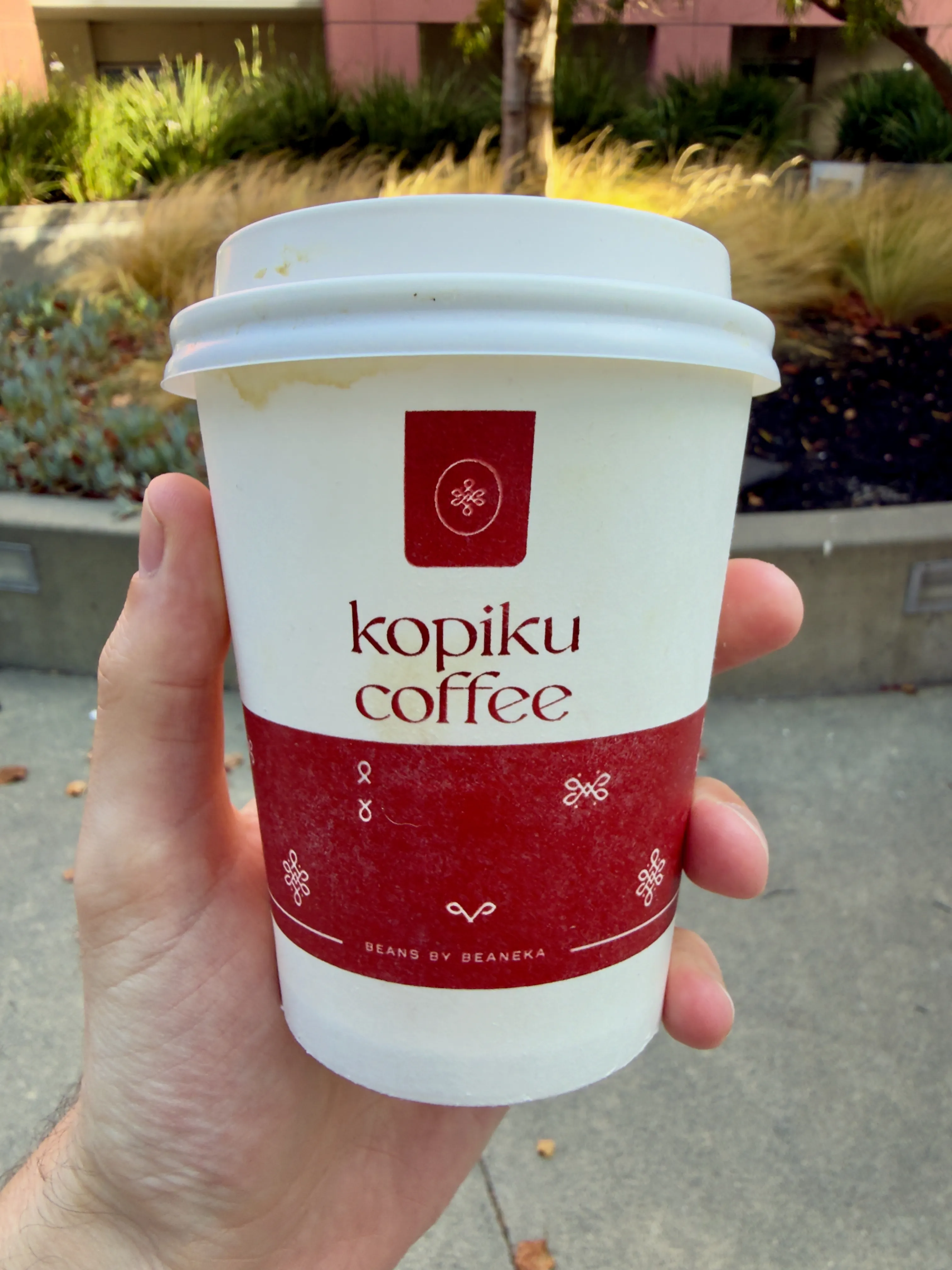 Front side of a coffee cup from Kopiku Coffee, showing their label Front side of a coffee cup from Kopiku Coffee, showing their label