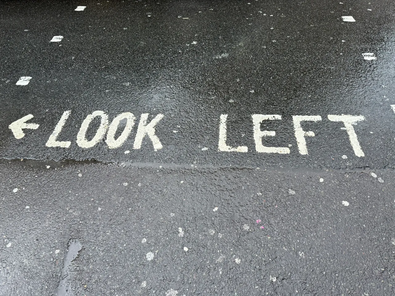 A street sign saying "Look Left"