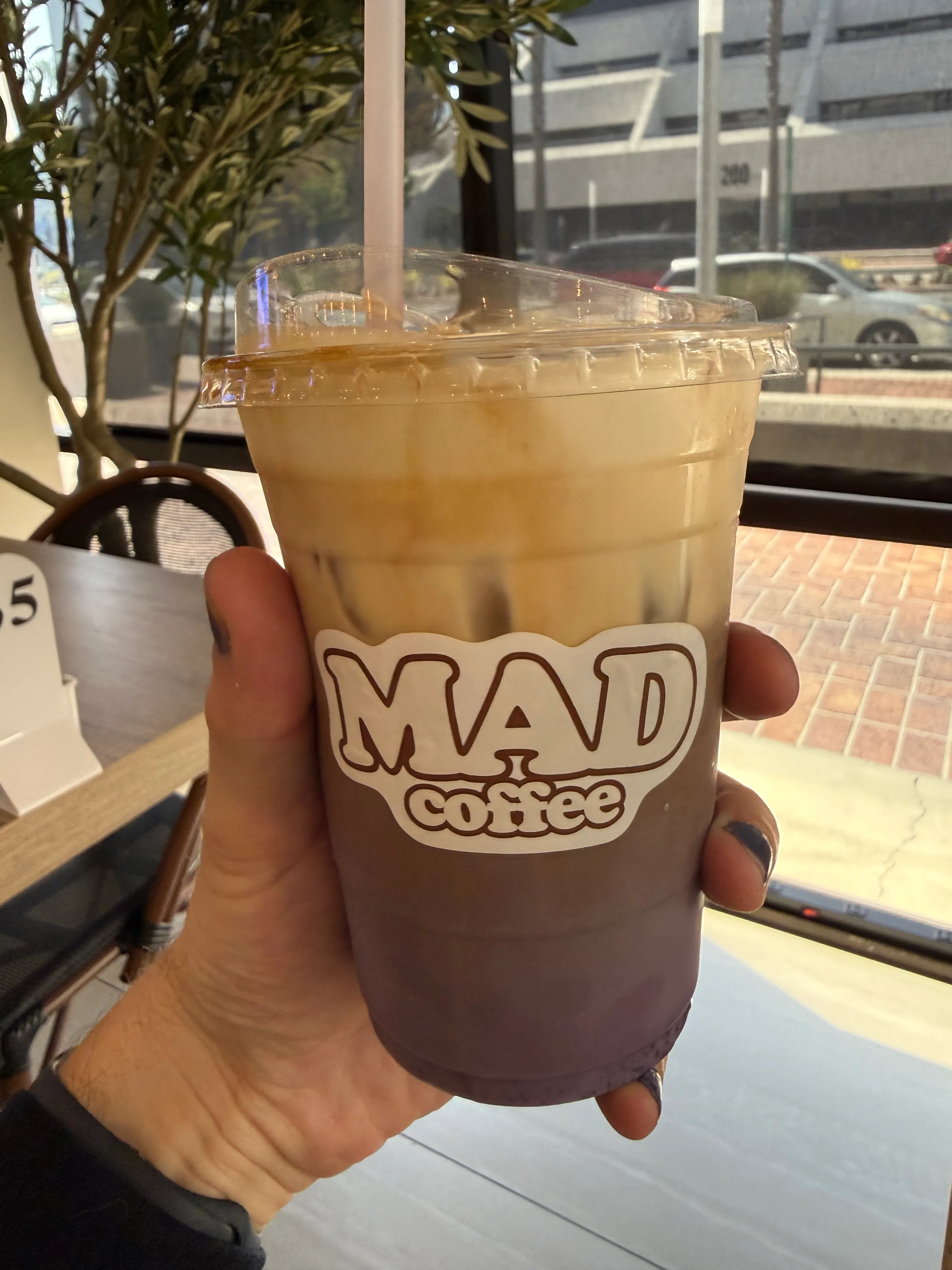 Front side of a coffee cup from Mad Coffee, showing their label Front side of a coffee cup from Mad Coffee, showing their label