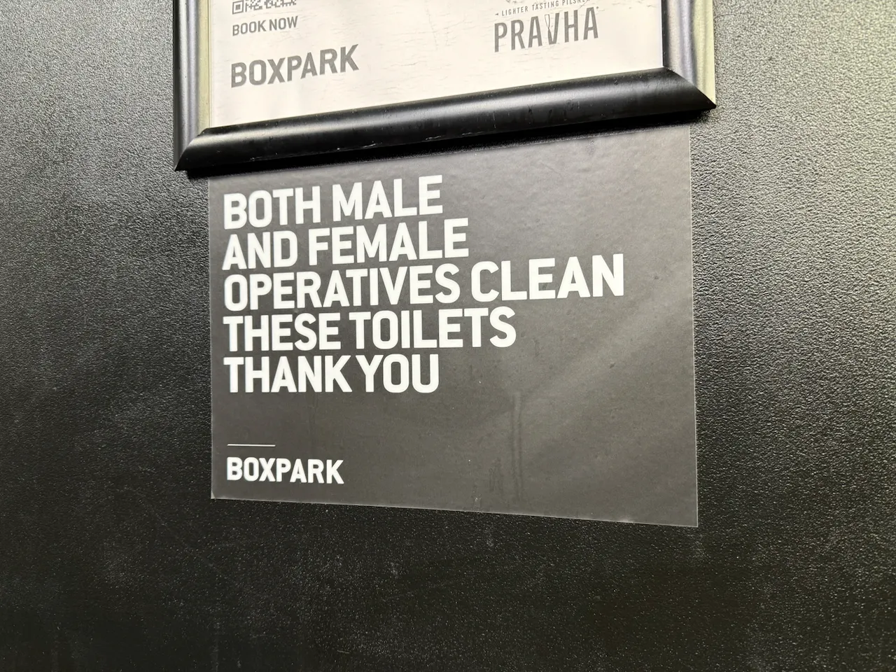 A sign reading "Both male and female operatives clean these toilets thank you"