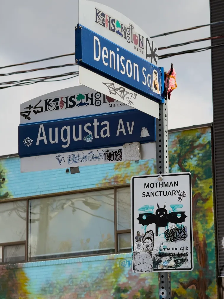 A street sign in Kensington, Toronto advertising a “Mothman Sanctuary”