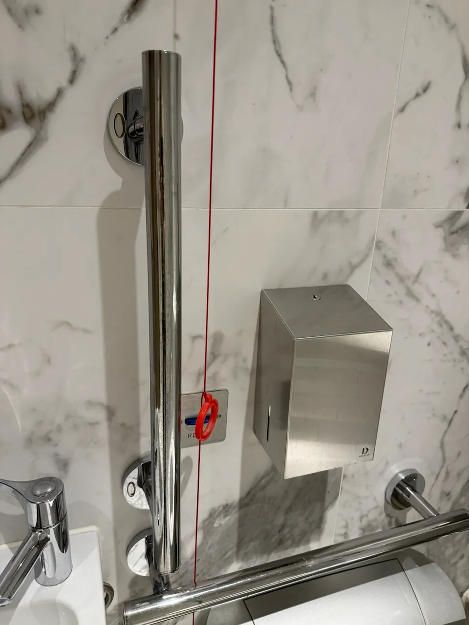 A red cord in a toilet