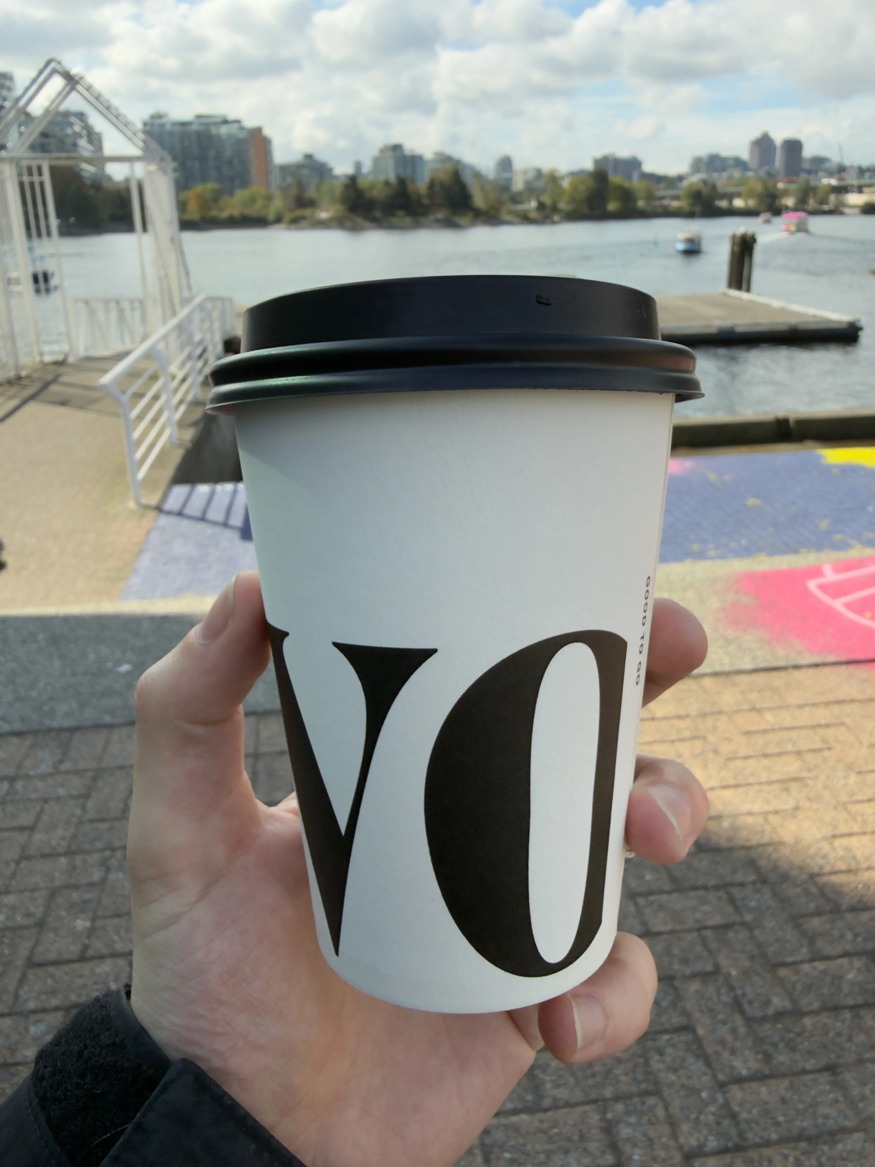 Back side of a coffee cup from Revolver, showing the vo of their logo Back side of a coffee cup from Revolver, showing the vo of their logo