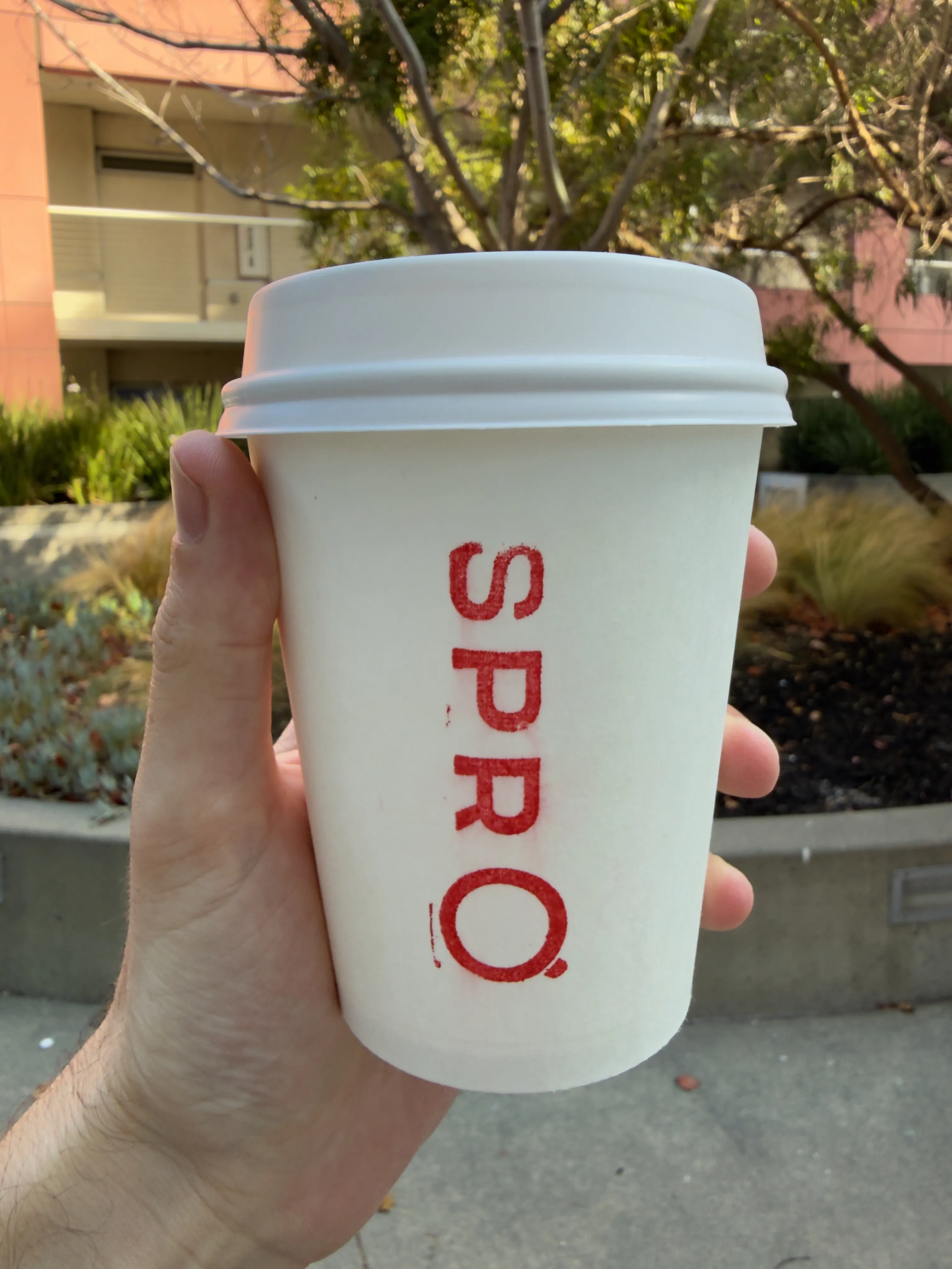 Front side of a coffee cup from SPRO, showing their label Front side of a coffee cup from SPRO, showing their label