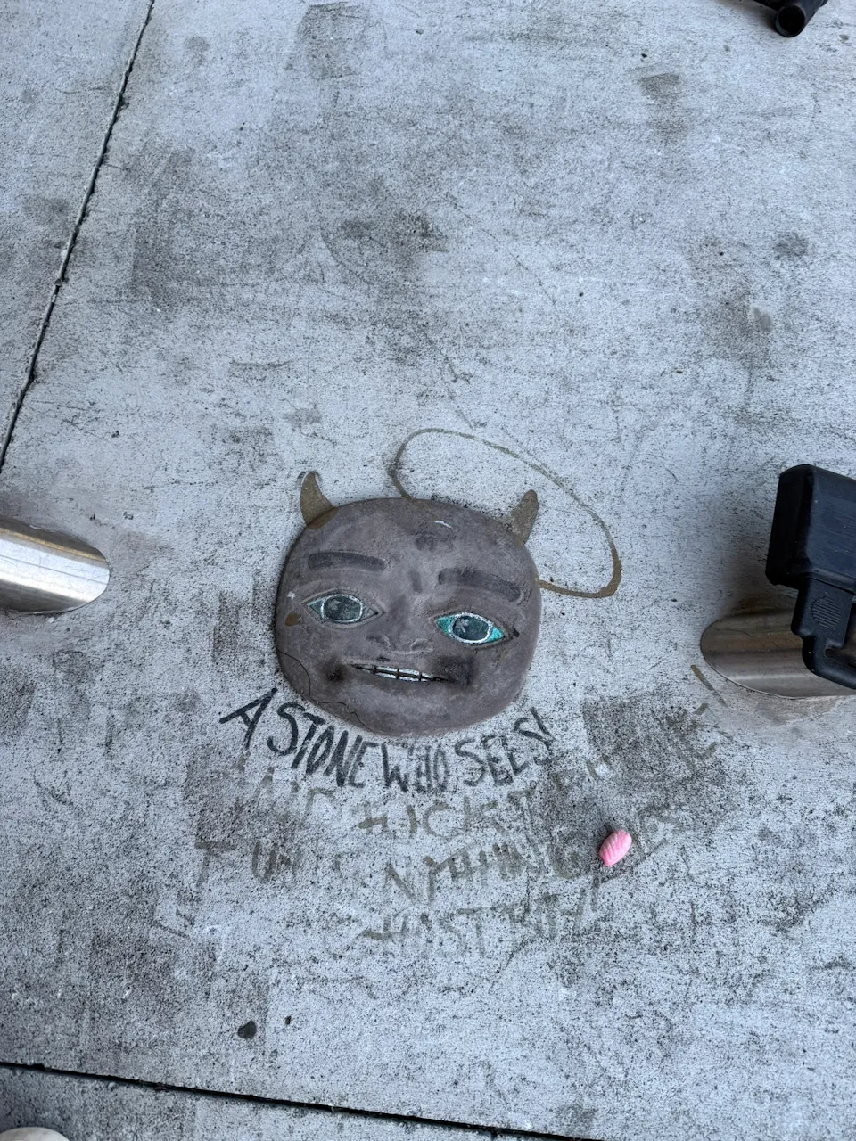 A stone on the ground with eyes labeled "A stone who sees!"